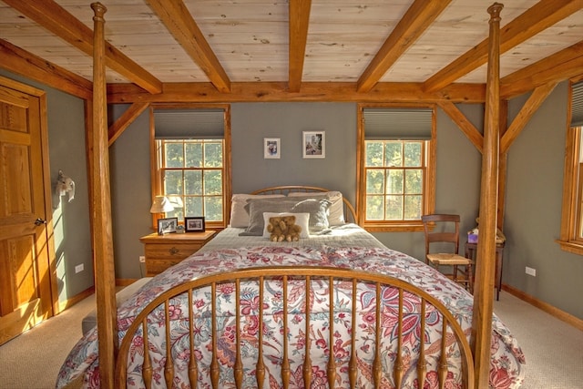 bedroom featuring multiple windows, carpet, and beam ceiling