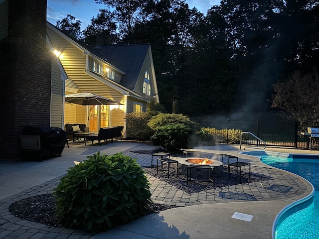 view of swimming pool featuring area for grilling, a patio area, and an outdoor fire pit