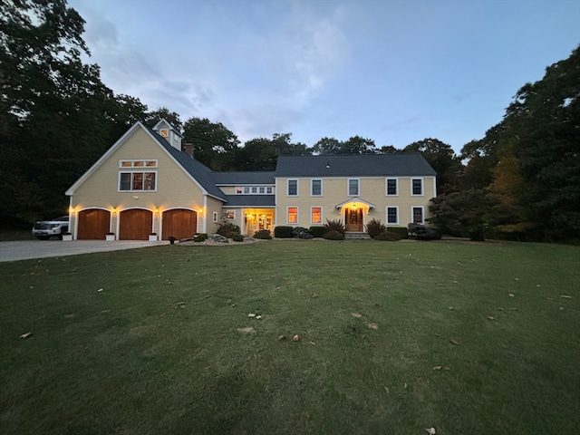 view of front facade featuring a yard and a garage