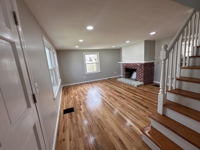 250 Gresham St, Springfield, MA 01119 - unfurnished living room featuring stairway, recessed lighting, wood finished floors, and a fireplace