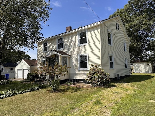 250 Gresham St, Springfield, MA 01119 - view of front of house featuring a chimney, a front lawn, an outdoor structure, and a garage
