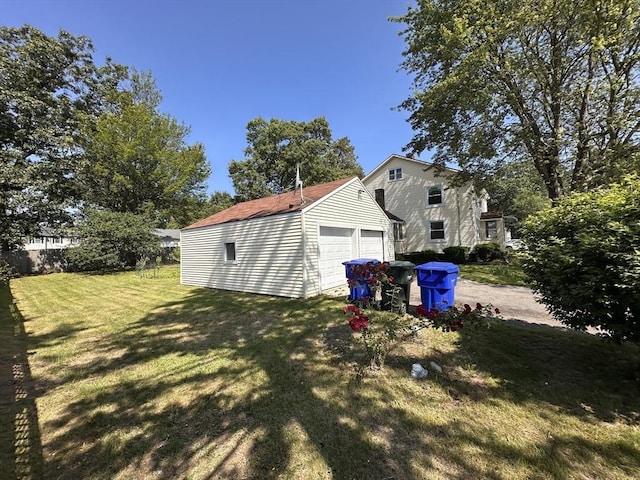 250 Gresham St, Springfield, MA 01119 - view of grassy yard featuring a detached garage and an outbuilding