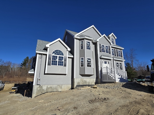 view of front of property with roof with shingles