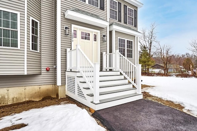 view of snow covered property entrance