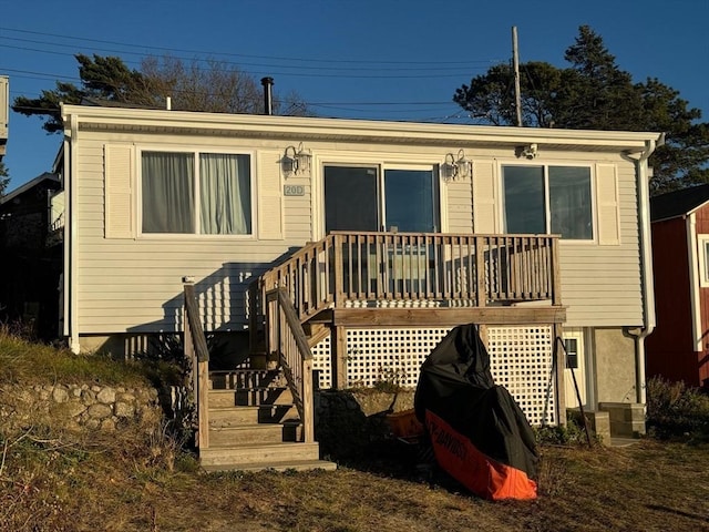 back of house featuring a wooden deck