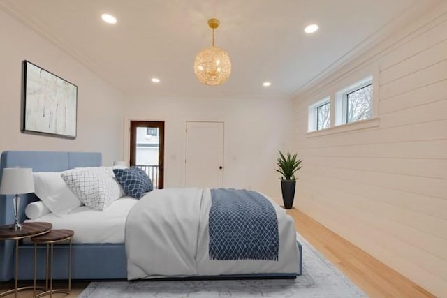 bedroom with ornamental molding, recessed lighting, multiple windows, and wood finished floors