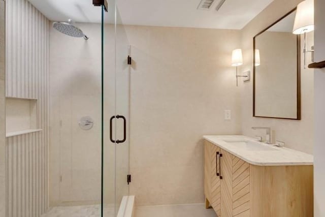 full bath featuring a shower stall, visible vents, and vanity