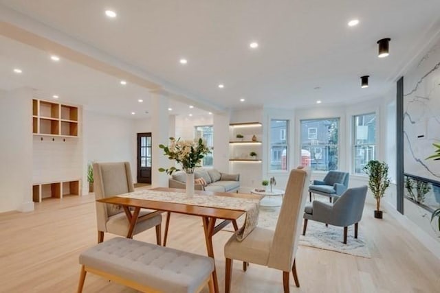 dining space featuring light wood-type flooring and recessed lighting