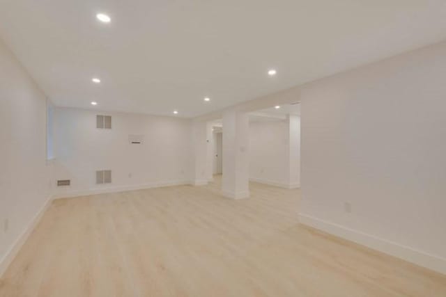 unfurnished room with light wood-style flooring, visible vents, and recessed lighting