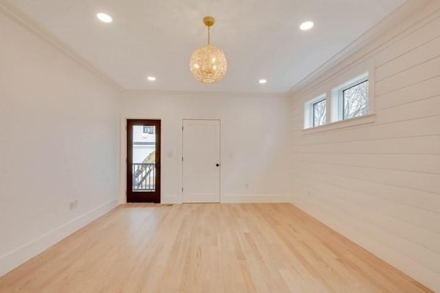 interior space with plenty of natural light, baseboards, light wood-style flooring, and crown molding