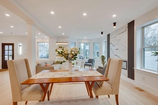 dining area with recessed lighting, light wood-type flooring, visible vents, and a healthy amount of sunlight