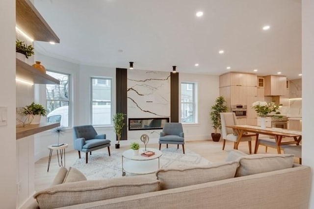 living area with baseboards and recessed lighting