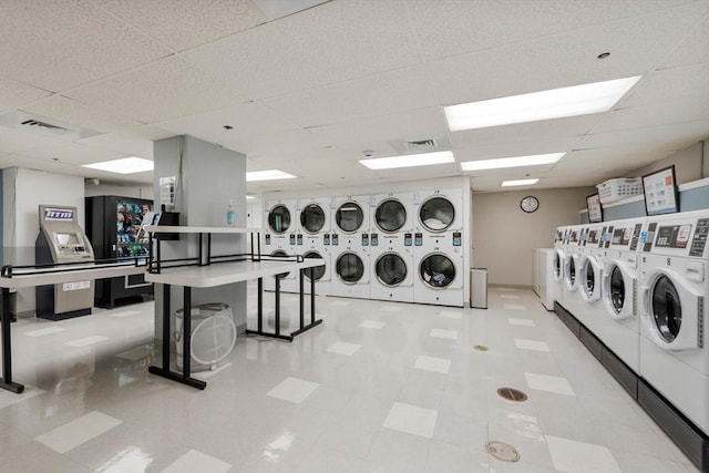 common laundry area featuring tile patterned floors, visible vents, washer and clothes dryer, and stacked washer and clothes dryer