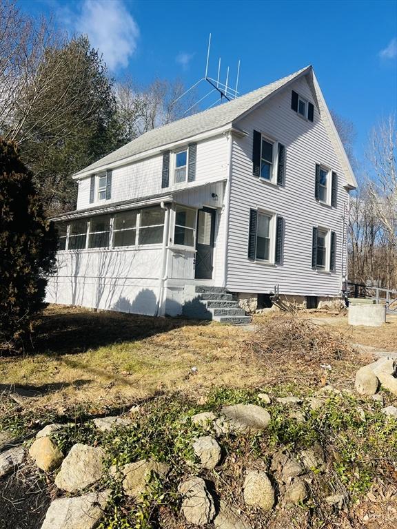 view of front of property featuring a sunroom