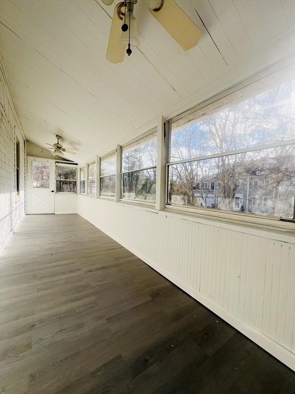 unfurnished sunroom with lofted ceiling