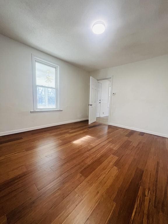 unfurnished room with dark hardwood / wood-style floors