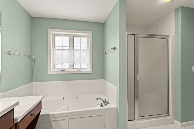 bathroom with tile patterned flooring, separate shower and tub, and vanity