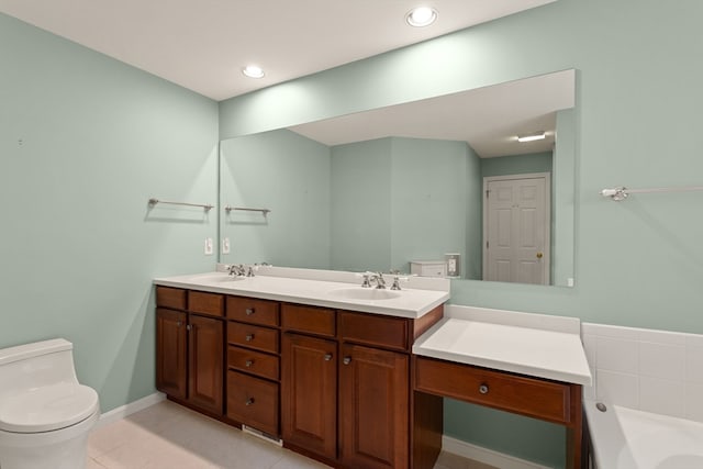 bathroom featuring tile patterned floors, a tub, vanity, and toilet