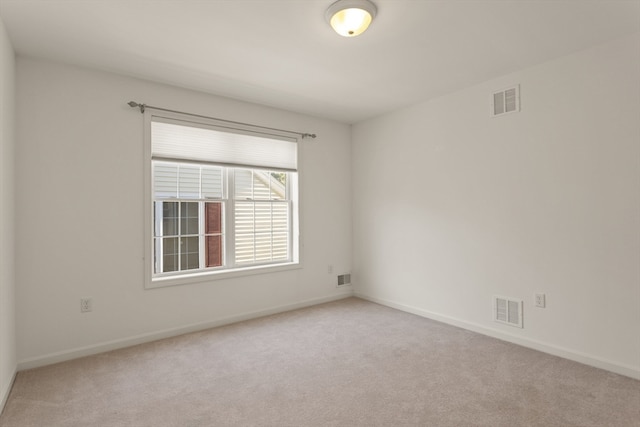 spare room with light colored carpet