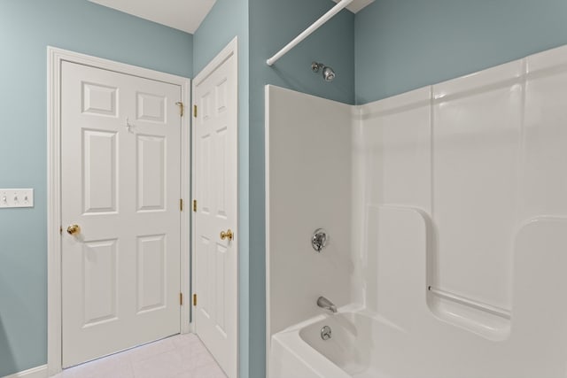 bathroom with tile patterned flooring and shower / washtub combination