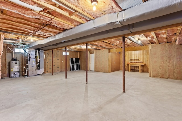 basement featuring gas water heater and heating unit