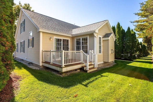 rear view of house with a yard and a deck