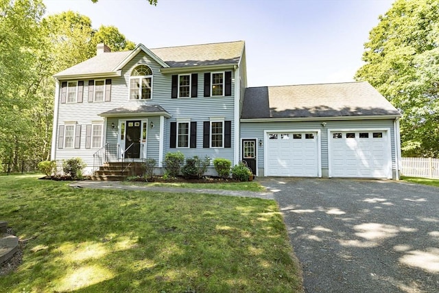 619 Pond St, Weymouth, MA 02190 - colonial inspired home featuring an attached garage, a chimney, asphalt driveway, and roof with shingles