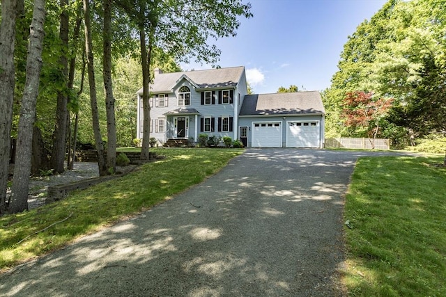 619 Pond St, Weymouth, MA 02190 - colonial house with driveway, a garage, a chimney, and a front yard