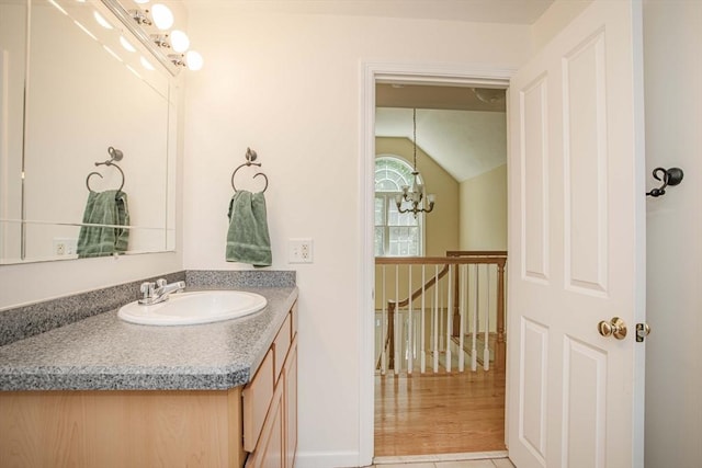 619 Pond St, Weymouth, MA 02190 - bathroom featuring lofted ceiling, vanity, and a chandelier