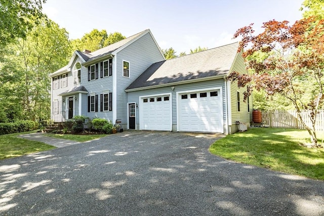 619 Pond St, Weymouth, MA 02190 - colonial-style house with a garage, asphalt driveway, and roof with shingles