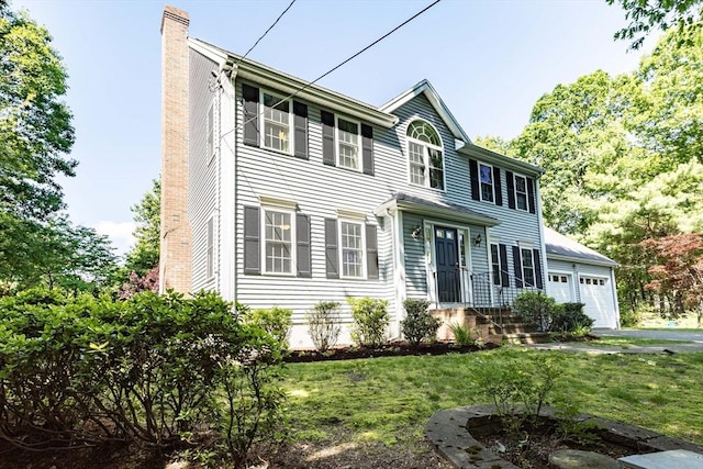 619 Pond St, Weymouth, MA 02190 - colonial house with a chimney, a front lawn, and a detached garage