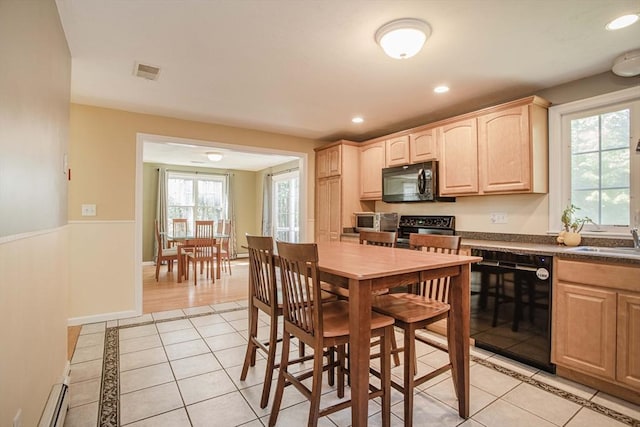 619 Pond St, Weymouth, MA 02190 - kitchen featuring black appliances, light brown cabinets, a baseboard radiator, light tile patterned floors, and dark countertops