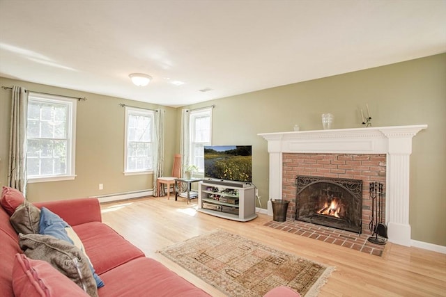 619 Pond St, Weymouth, MA 02190 - living area with wood finished floors, a baseboard heating unit, a brick fireplace, and baseboards