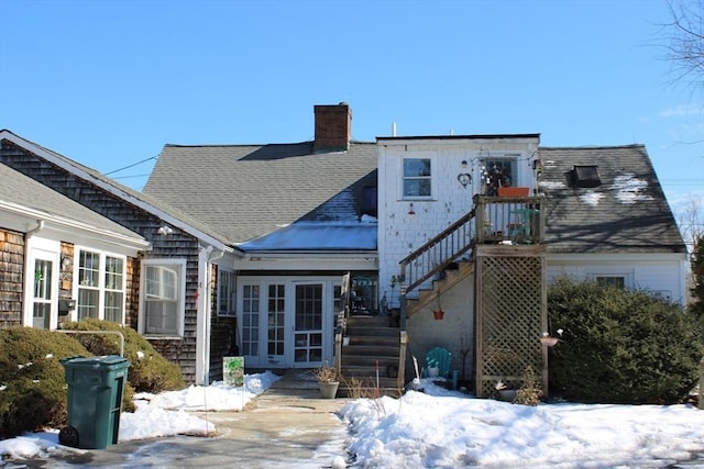 676 Bedford St, Abington, MA 02351 - snow covered house featuring french doors, a chimney, stairs, and a shingled roof