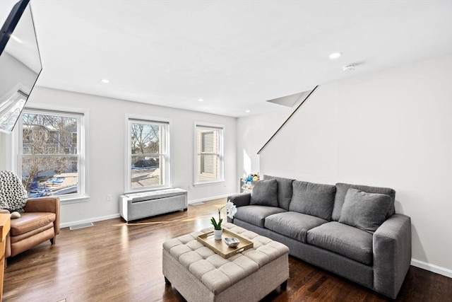 living room with dark hardwood / wood-style flooring