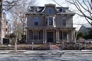 view of front of home with covered porch and a fenced front yard