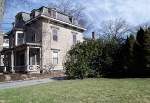 exterior space with a porch and a yard