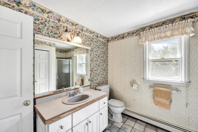 bathroom with a shower stall, vanity, tile patterned floors, toilet, and a baseboard radiator