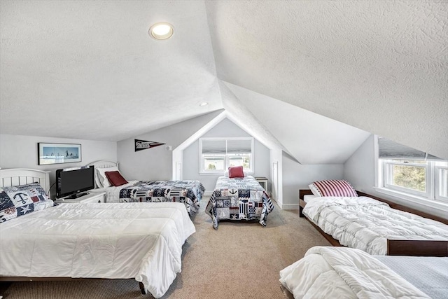 carpeted bedroom with a textured ceiling and vaulted ceiling