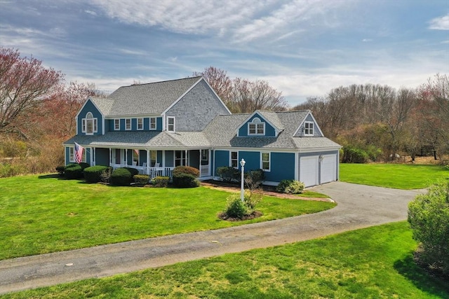 view of front facade featuring a garage, a porch, driveway, and a front yard
