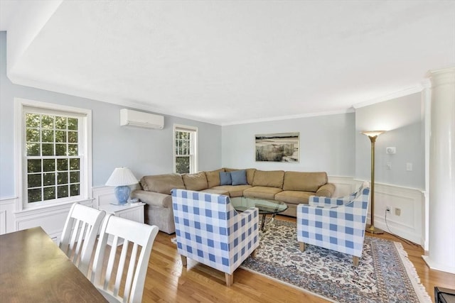 living area with a wealth of natural light, wood finished floors, and a wall unit AC