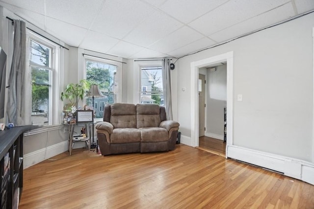 45-47 Crescent St, Swampscott, MA 01907 - living room featuring light wood-type flooring, a paneled ceiling, and baseboards