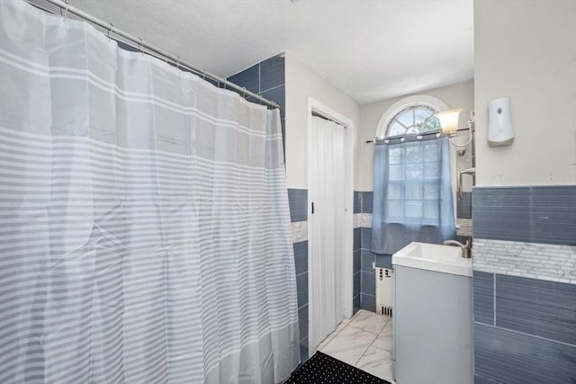 45-47 Crescent St, Swampscott, MA 01907 - bathroom with tile walls, vanity, wainscoting, marble look tile flooring, and a shower with curtain