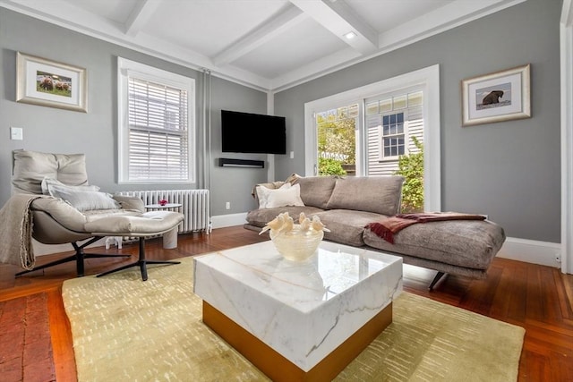 living room featuring radiator, beam ceiling, baseboards, and wood finished floors
