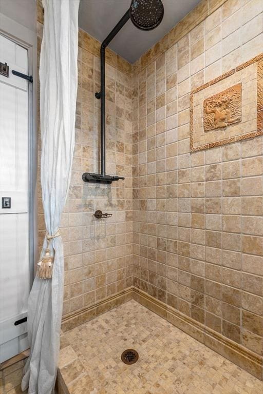 bathroom with tiled shower