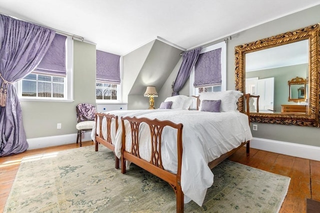 bedroom featuring hardwood / wood-style flooring and baseboards