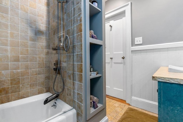 bathroom featuring vanity and washtub / shower combination