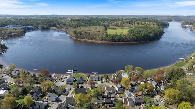 birds eye view of property featuring a water view, a residential view, and a view of trees