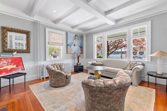 sitting room featuring radiator and beam ceiling