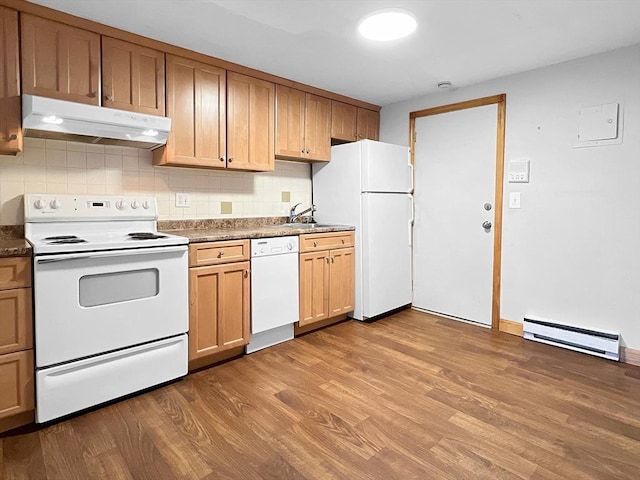 kitchen with backsplash, a baseboard heating unit, wood finished floors, white appliances, and under cabinet range hood